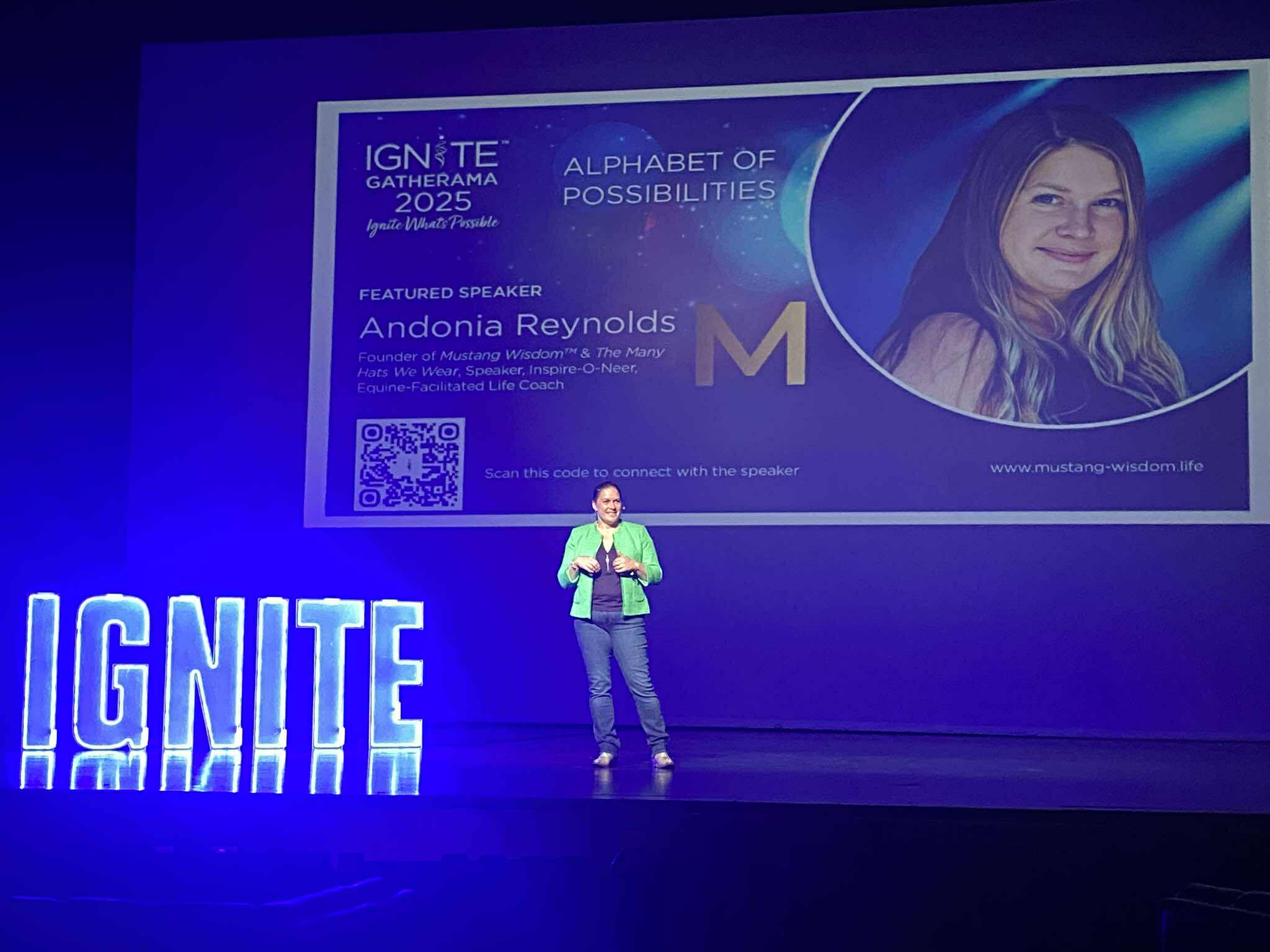 Ignite speaking event with green coat on stage